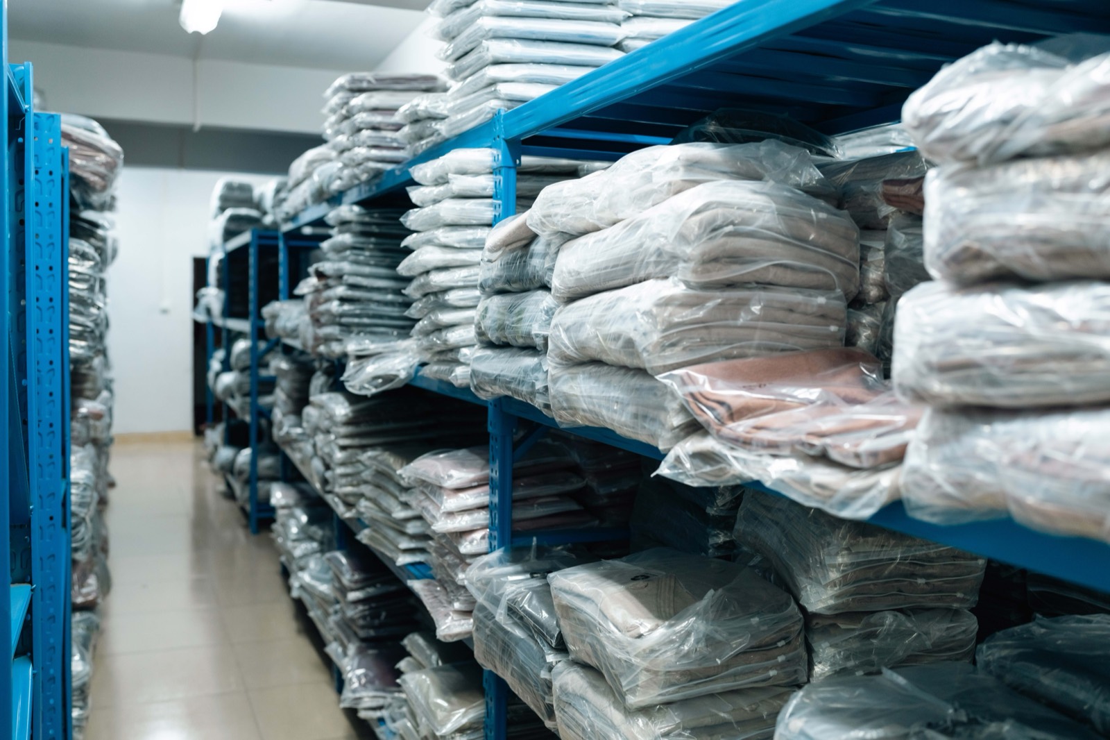 Shelving racks stacked with polybagged finished knitwear